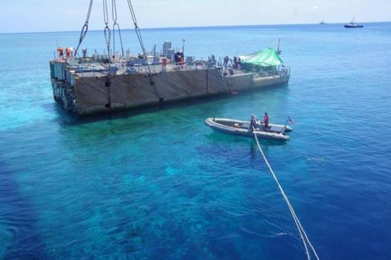 Ongoing operations to lift the middle section of the US Navy ship USS Guardian in the Tubbataha Reef