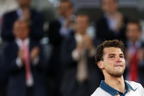 Dimitrov of Bulgaria celebrates his victory over Djokovic of Serbia at the end of their men''s singles match at the Madrid Open tennis tournament