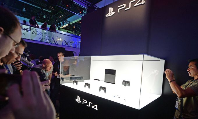 Attendees photograph the new Sony PlayStation 4