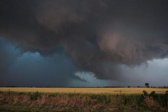 Large clouds are seen as a tornado passes south of El Reno, Oklahoma