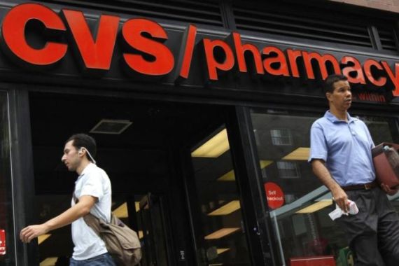 File photo of a man walking past a CVS pharmacy store in New York City