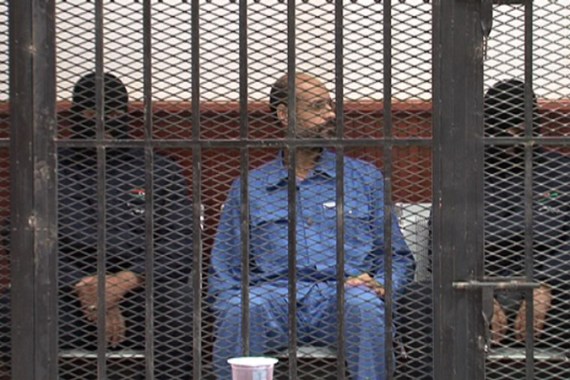This image made from video distributed by the Zintan Media Center shows Seif al-Islam Gadhafi, center, inside a defendant''s cage in a courtroom in Zintan, Libya, Thursday, May 2, 2013. The imprisoned son of Libya''s slain dictator Moammar Gadhafi appeared in court on Thursday on charges of harming state security, but the judge adjourned his hearing until Sept. 19 to allow defense lawyers time to study the case.(AP Photo/Zintan Media Center)
