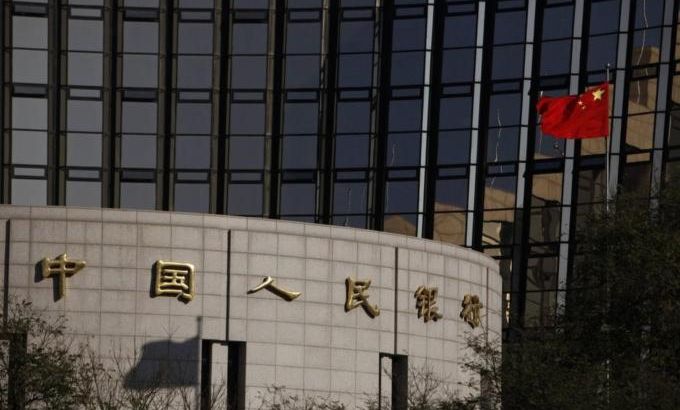 File photo of China''s nation flag flying in front of the headquarters of the People''s Bank of China, the central bank, in Beijing