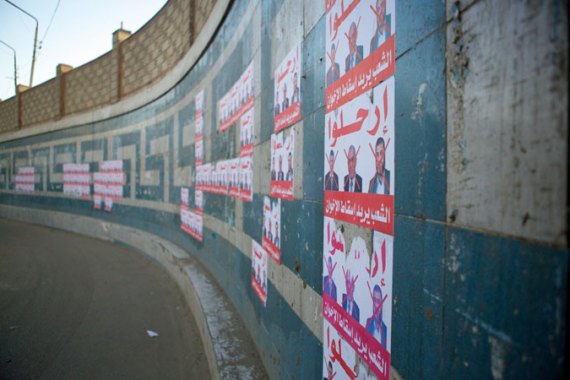 Signs reading "Leave!" above pictures of Morsi and other prominent Brotherhood officials on a main road in Zagazig, the capital of Sharqiya governorate [Gregg Carlstrom/Al Jazeera]