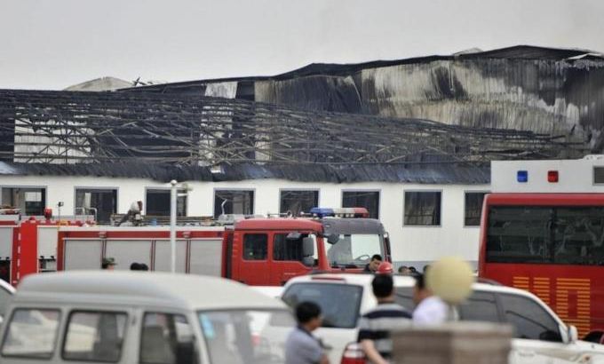 Rescue workers and fire trucks are seen outside a site of a fire, at a poultry slaughterhouse in Dehui