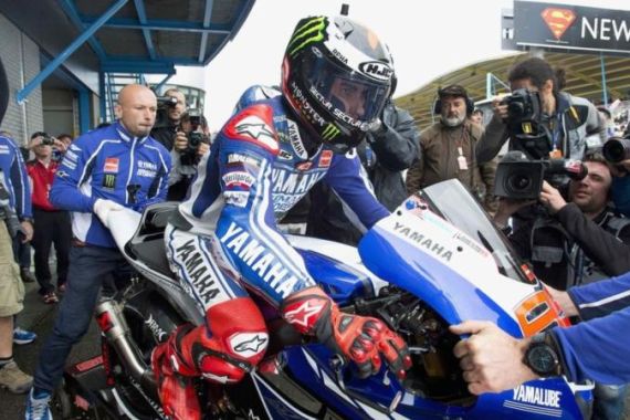 Yamaha MotoGP rider Lorenzo climbs prepares for first practice of the Dutch Grand Prix in Assen