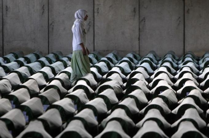 A Bosnian woman tries to find the coffin of her relative in Potocari Memorial Center. [Reuters]