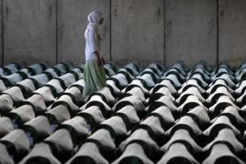 A Bosnian woman tries to find the coffin of her relative in Memorial Center Potocari near Srebrenica
