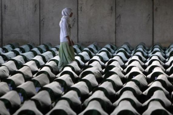 A Bosnian woman tries to find the coffin of her relative in Memorial Center Potocari near Srebrenica
