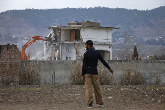 A policeman looks on as the building where al Qaeda leader Osama bin Laden was killed is demolished in Abbottabad
