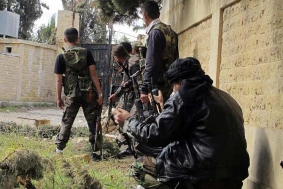 File picture shows Free Syrian Army fighters taking up position during clashes with forces loyal to Syria''s President Assad in Khan al-Assal