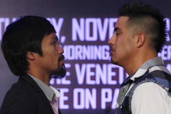 Filipino boxer Manny Pacquiao and Brandon Rios of the U.S. face off during a news conference in Macau