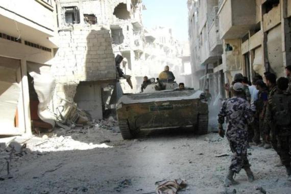 Forces loyal to Syria''s President Bashar al-Assad are seen at al Khaldia neighbourhood in Homs city
