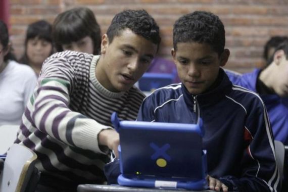 Second grade high school students check their brand new XO low-cost laptop computers at a public high school in Casabo