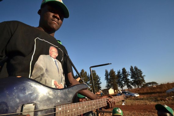 Mugabe supporter plays guitar [Azad Essa/Al Jazeera]