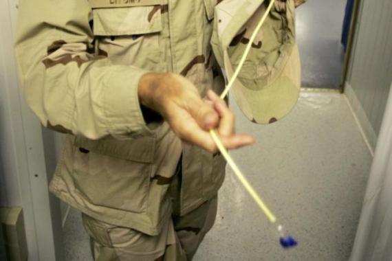 Military doctor who asked to not be identified holds a feeding tube for detainees who hunger strike at Camp Delta at the Guantanamo Bay Naval Station