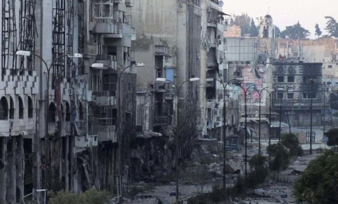 Destroyed buildings are seen on a deserted street in Homs