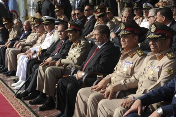 Egypt''s new President Mursi and Field Marshal Tantawi, head of Egypt''s ruling SCAF, attend a ceremony where the military handed over power to Mursi at a military base in Hikstep