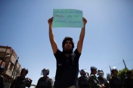 An activist holds up a placard during a protest against the U.S. drone strikes in Yemen outside the U.S. embassy in Sanaa