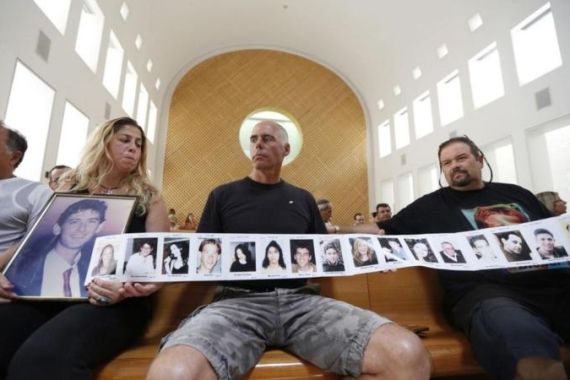 Israelis hold pictures of their family members who were killed by Palestinians during a protest against the release of Palestinian prisoners, in Jerusalem