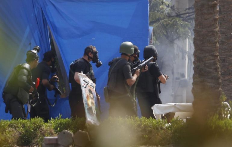 Riot police are seen during a clash with members of the Muslim Brotherhood and supporters of deposed Egyptian President Mohamed Mursi, at Rabaa Adawiya square, where they are camping, in Cairo