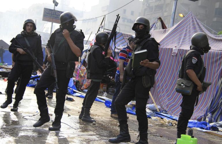 Riot police clear the area of members of the Muslim Brotherhood and supporters of deposed Egyptian President Mohamed Mursi, at Rabaa Adawiya square, where they are camping, in Cairo
