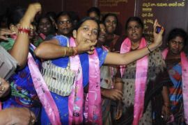 Telangana supporters cheer as they celebrate after the announcement of the separate state of Telangana at their party headquarters in Hyderabad