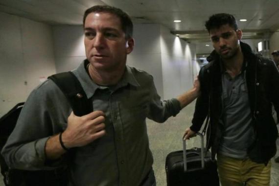 U.S. journalist Greenwald walks with his partner Miranda in Rio de Janeiro''s International Airport
