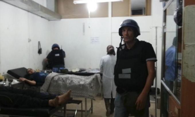 U.N. chemical weapons experts visit wounded people affected by an apparent gas attack, at a hospital in the southwestern Damascus suburb of Mouadamiya