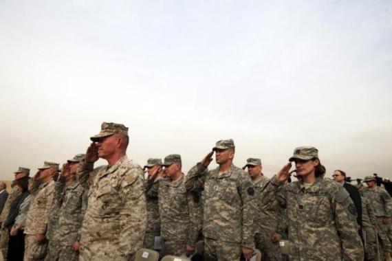 Members of U.S. military salute during ceremony to retire U.S. military''s ceremonial flag, signifying end of U.S. military presence in Iraq, at Baghdad Diplomatic Support Center