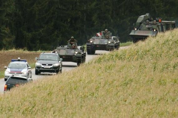 Austrian army APCs approach a crime scene near Melk some 80 km 50 miles west of Vienna