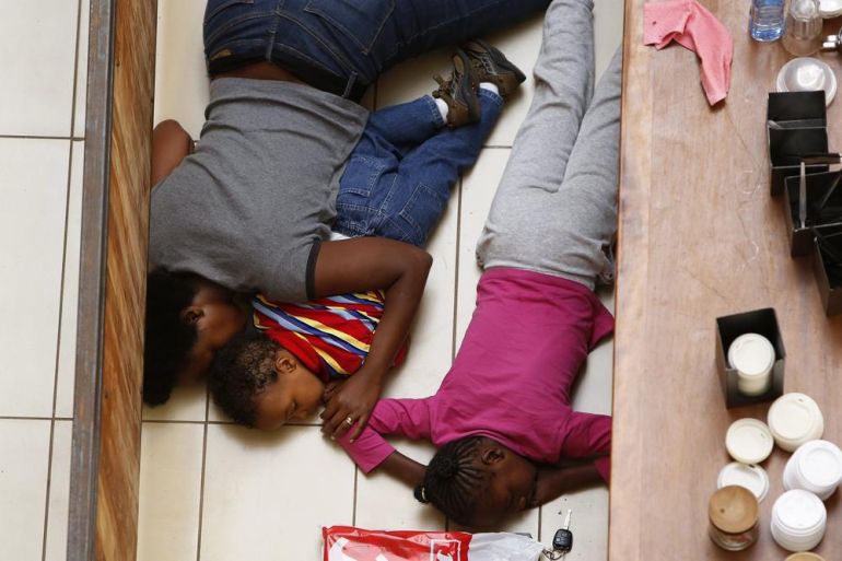 A mother and her children hide from gunmen at Westgate Shopping Centre in Nairobi