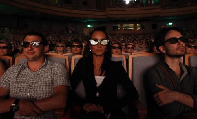 People wear 3D glasses as they watch a live broadcast of the Swan Lake ballet performance, at the recently opened Mariinsky II Theatre in St. Petersburg