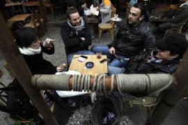 Syrians sit at a cafe in the old city of