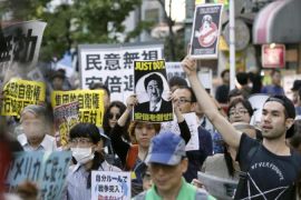 Japanese citizens have protested against a defence policy change by Prime Minister Shinzo Abe [EPA]