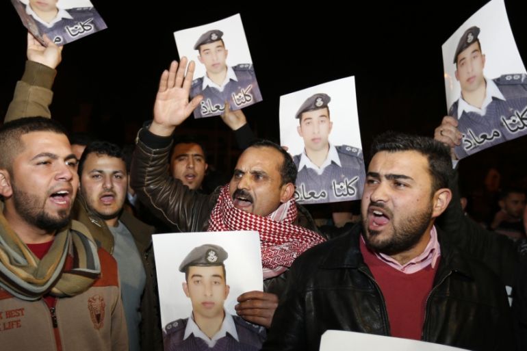 Relatives of Islamic State captive Jordanian pilot Muath al-Kasaesbeh hold up his pictures as they chant slogans during a demonstration in Amman