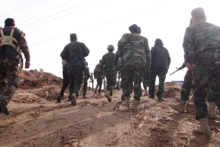 Kurdish Peshmerga walk to the frontline in Shandoukhah, northern Iraq