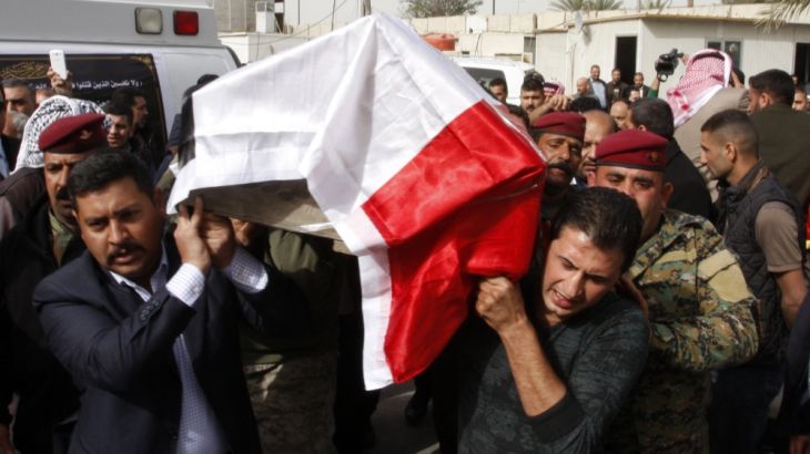 Mourners carry the coffin of prominent Iraqi Sunni tribal leader Sheikh Qassem al-Janabi