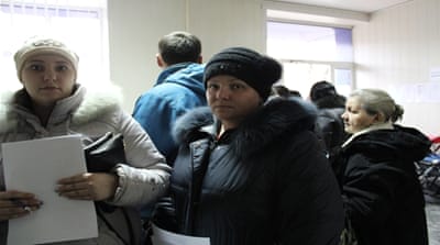 People stand in line at a centre to register as an internally displaced person. The UN estimated there are almost 1 million IDPs in east Ukraine [Kristina Jovanovski/Al Jazeera]