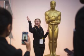 Hegedus, a talent production assistant, poses with an Oscar statue on the red carpet outside the Dolby Theatre in Hollywood, hours before arrivals for the Academy Awards in Los Angeles, California