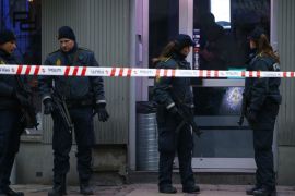 Police officers control the street in front of an internet cafe in Copenhagen