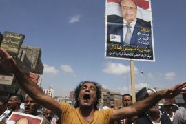 Protester shouts slogans during a demonstration to show support to Yemen''s ousted president Abd-Rabbu Mansour Hadi in Yemen''s southwestern city of Taiz