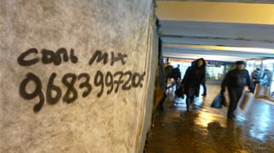 A hand-written telephone number of a 'spice' drug pusher in Moscow written on a wall in an underground pass [Mansur Mirovalev/Al Jazeera]