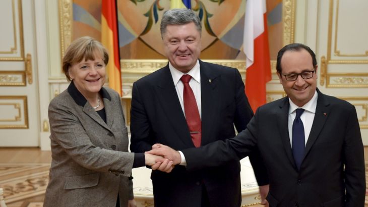 Ukraine''s President Poroshenko shakes hands with German Chancellor Merkel and French President Hollande during their meeting in Kiev