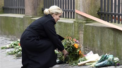 Denmark's Prime Minister Helle Thorning-Schmidt places flowers in front of the synagogue in Copenhagen [Reuters]