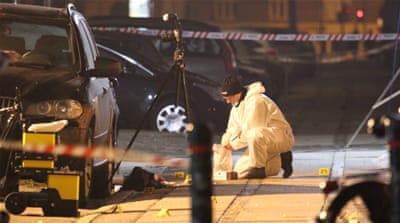 Forensic investigators at the site of a shooting [Reuters]