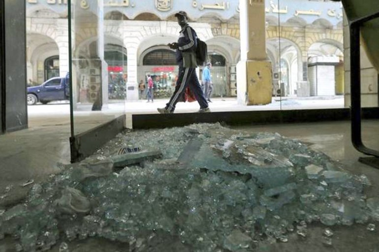 A passerby inspects the site of a blast in central Cairo