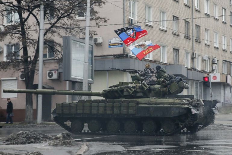 Pro-Russian separatists ride on a tank in Donetsk, eastern Ukraine