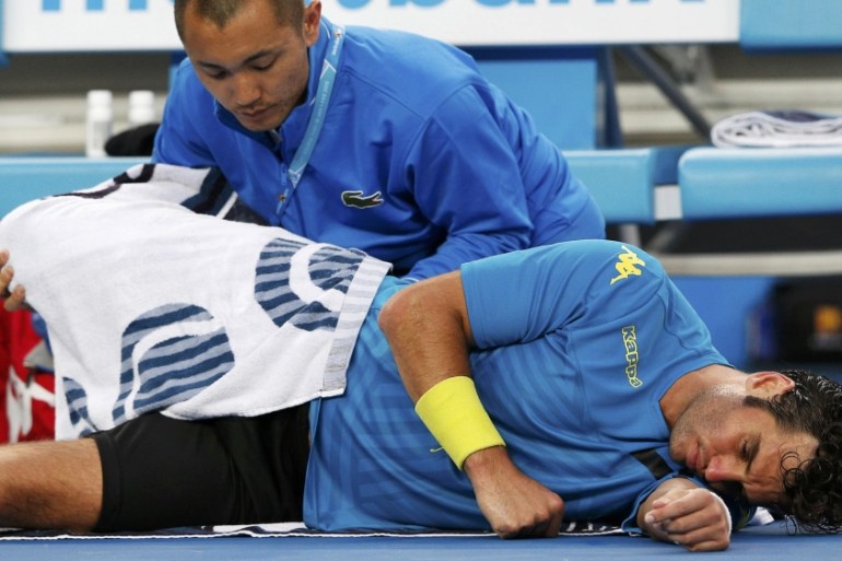 Malek Jaziri of Tunisia receives medical treatment during his men''s singles third round match against Nick Kyrgios of Australia at the Australian Open 2015 tennis tournament in Melbourne