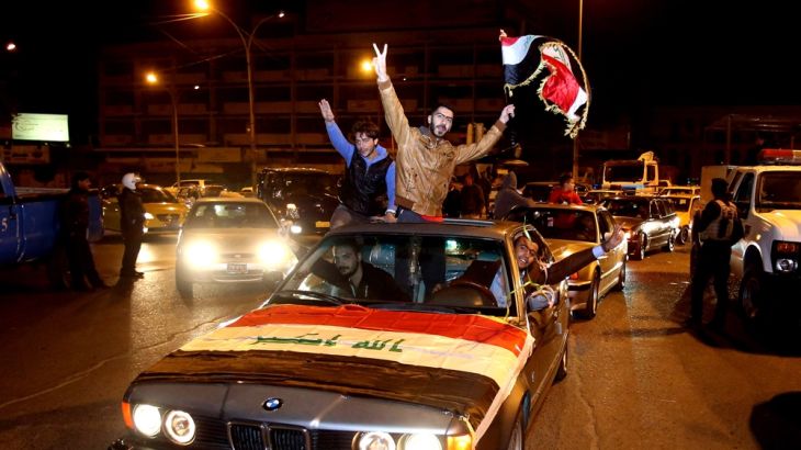Iraqis celebrate after the lifting of Baghdad''s night-time curfew